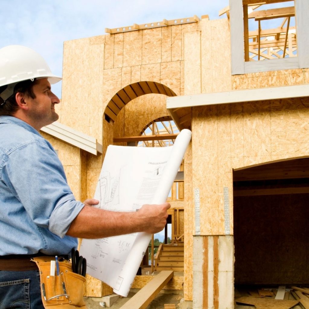 A contractor review blueprints for a construction.